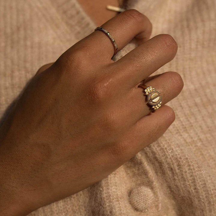 Model wearing gold open and stacking rings