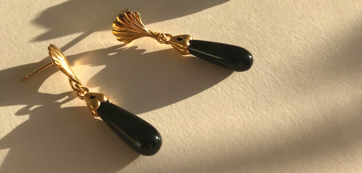 Gold and onyx handmade drop earrings, a long black piece of smooth onyx hangs down for a scallop shell earring