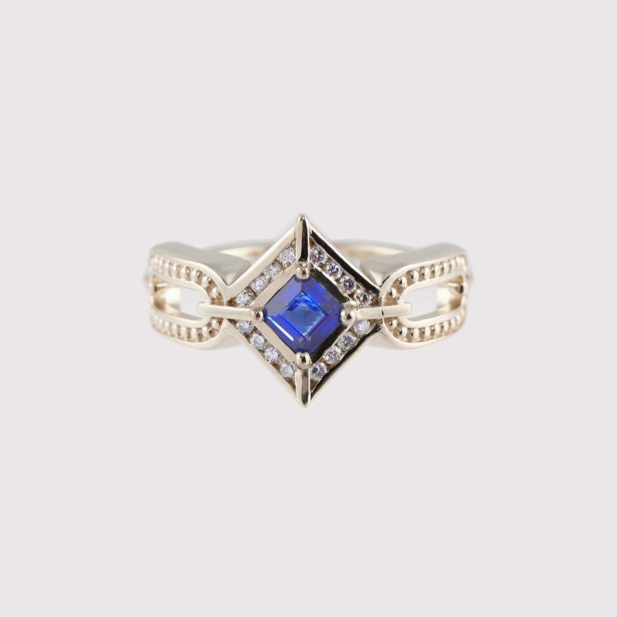 Geometric Art Deco engagement ring with princess cut brilliant blue sapphire