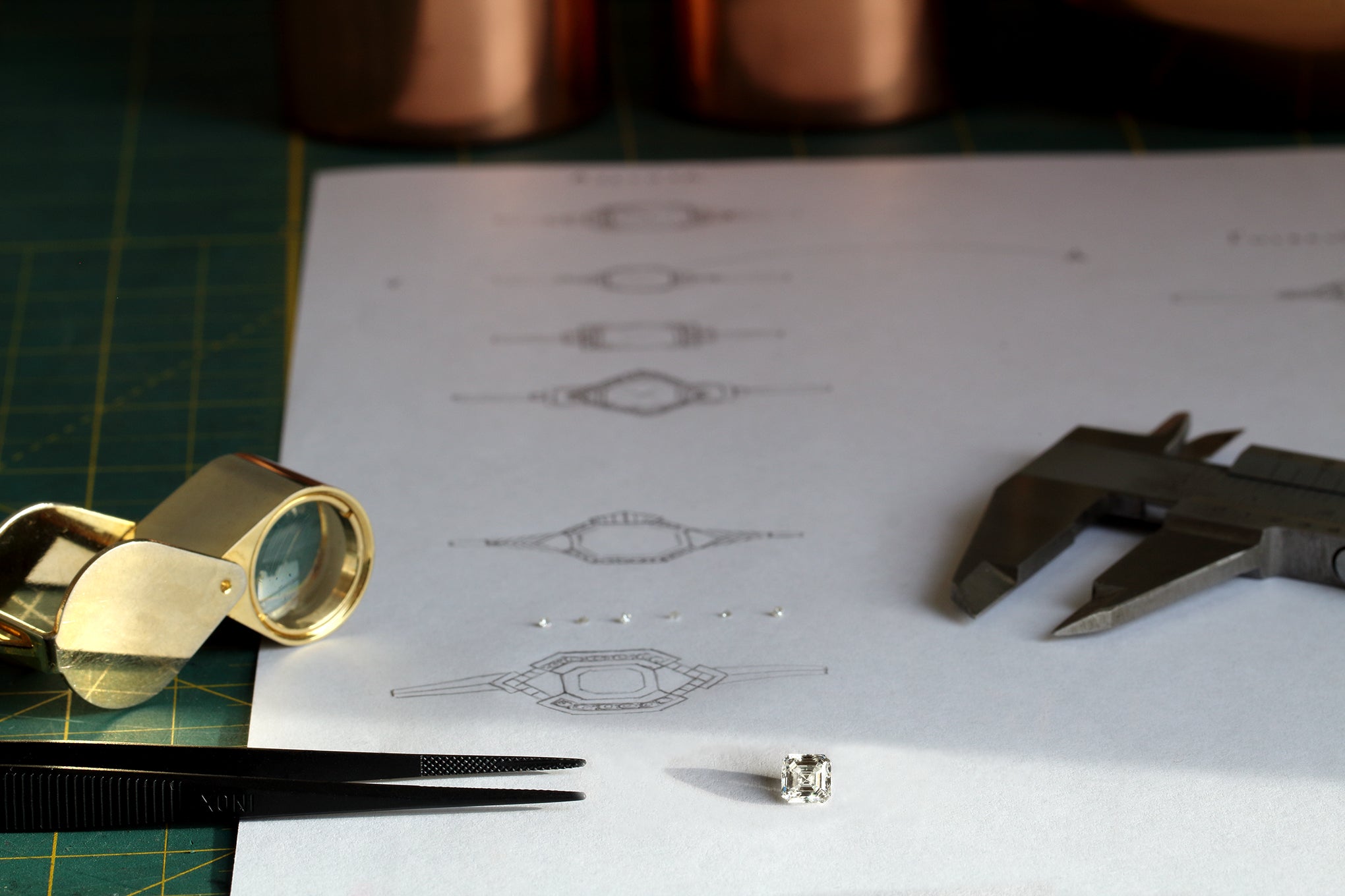 Designing an engagement ring, with diamond, tweezers and calipers
