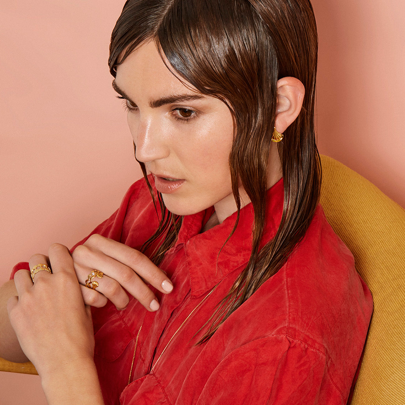 Model in red blouse wearing gold jewellery
