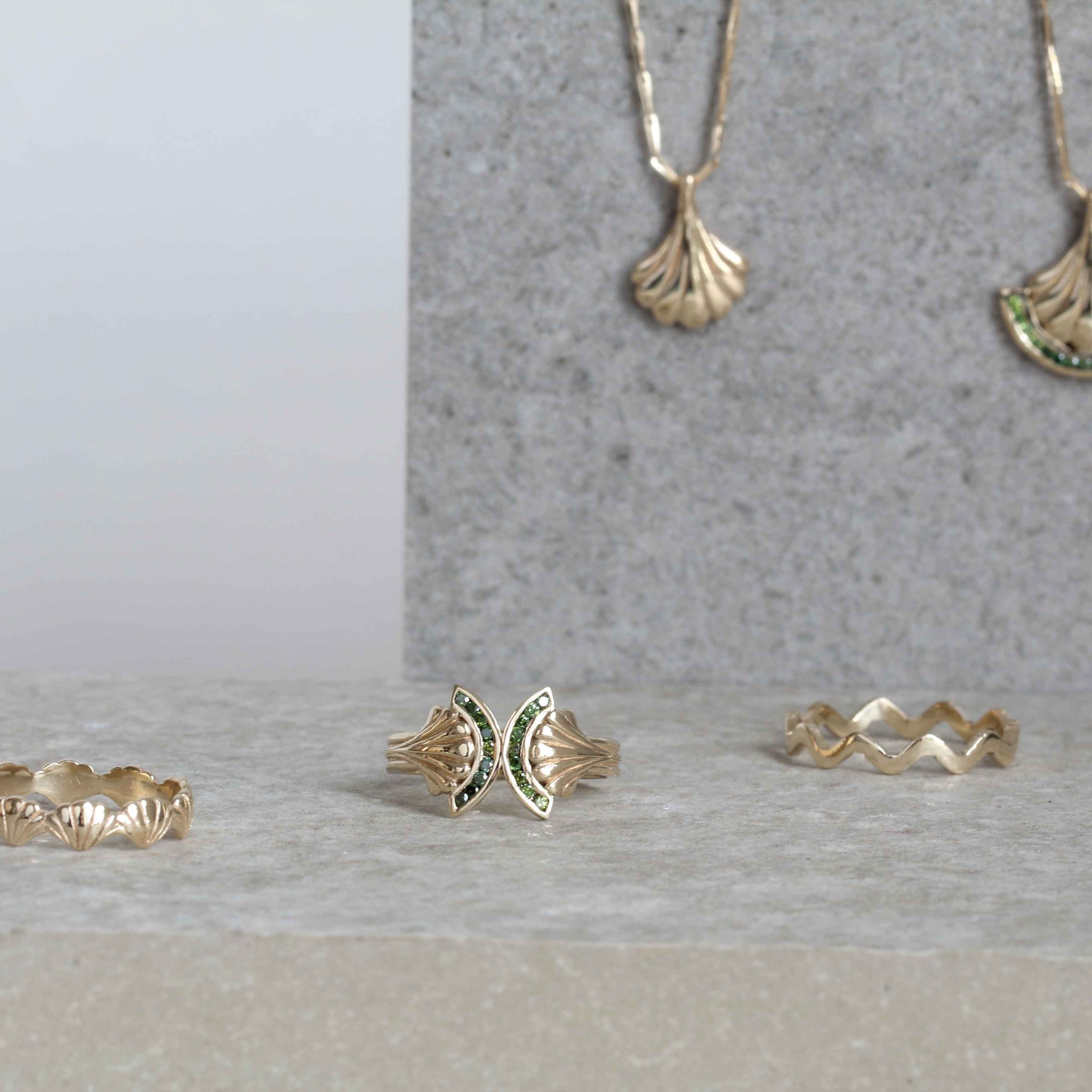 Selection of gold art deco jewellery on limestone slab