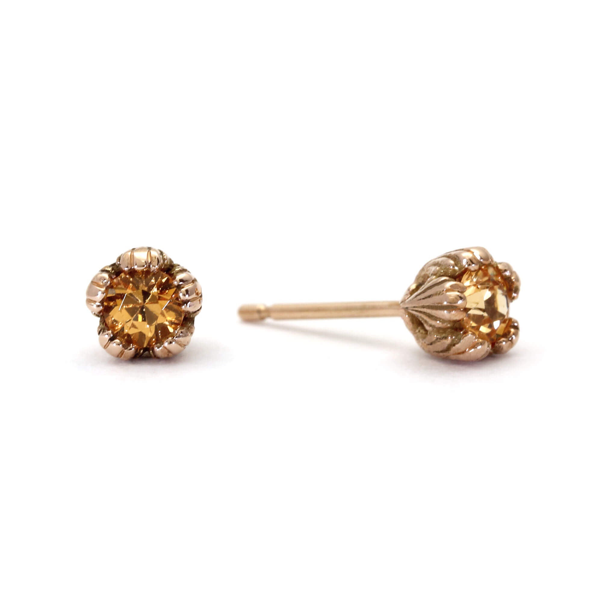 A pair of solid gold and spessartite garnet stud earrings