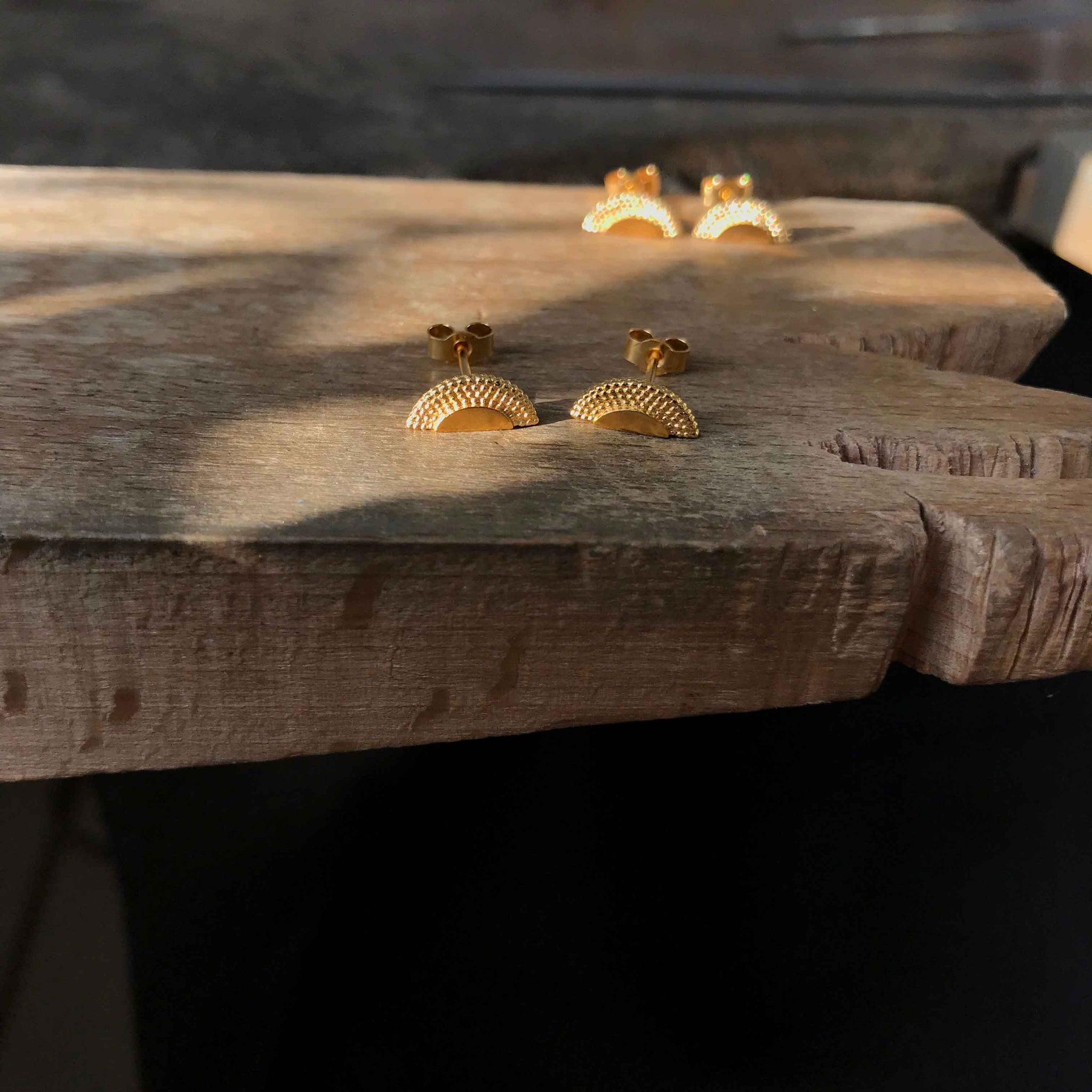 2 pairs of gold studs on gnarled quarter sawn oak board