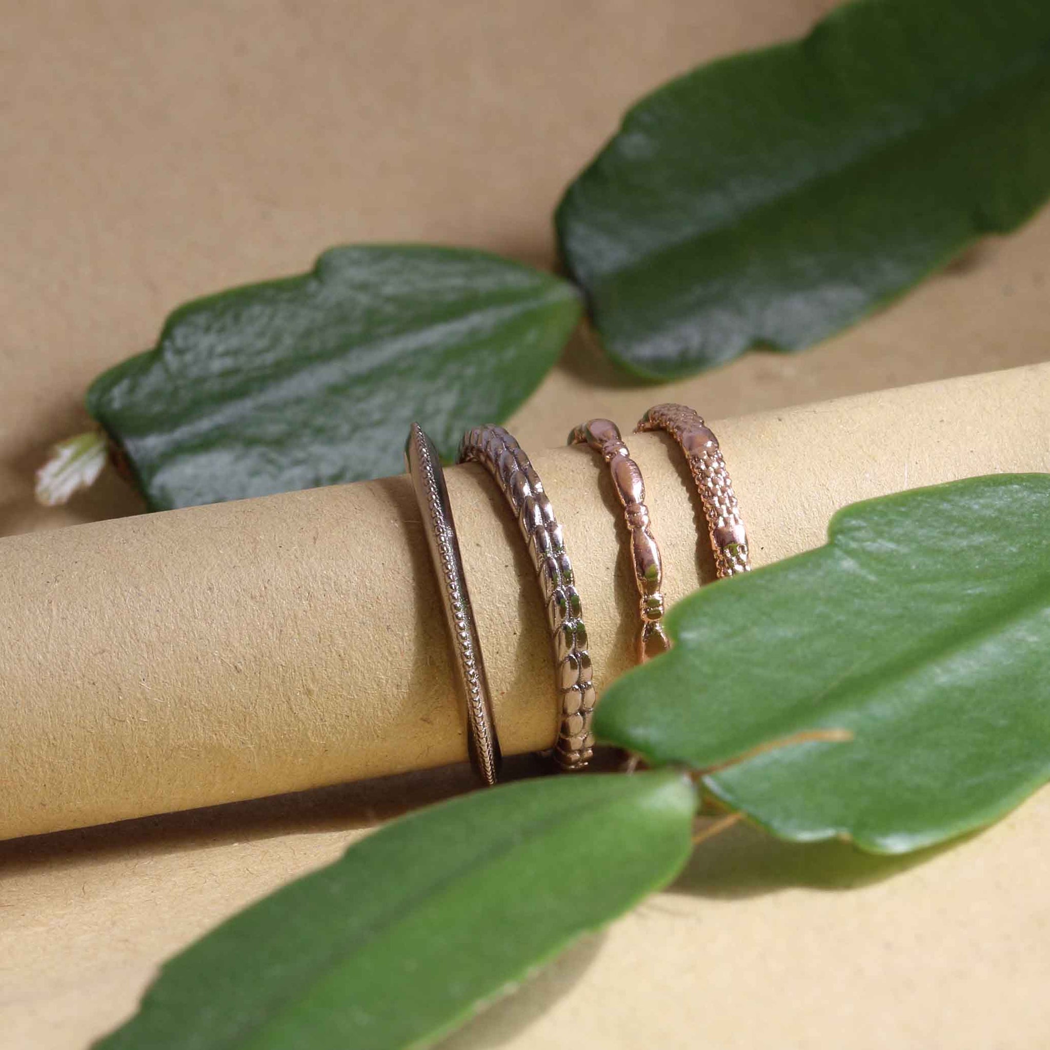 White and yellow gold rings on roll of recycled paper