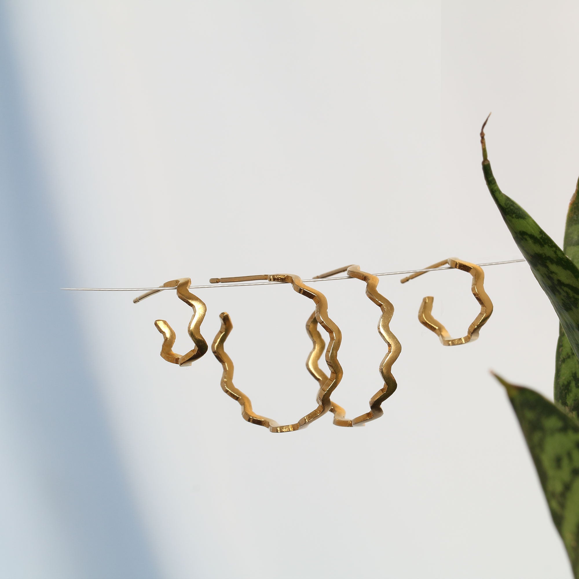 4 gold wavy hoop earrings on a wire